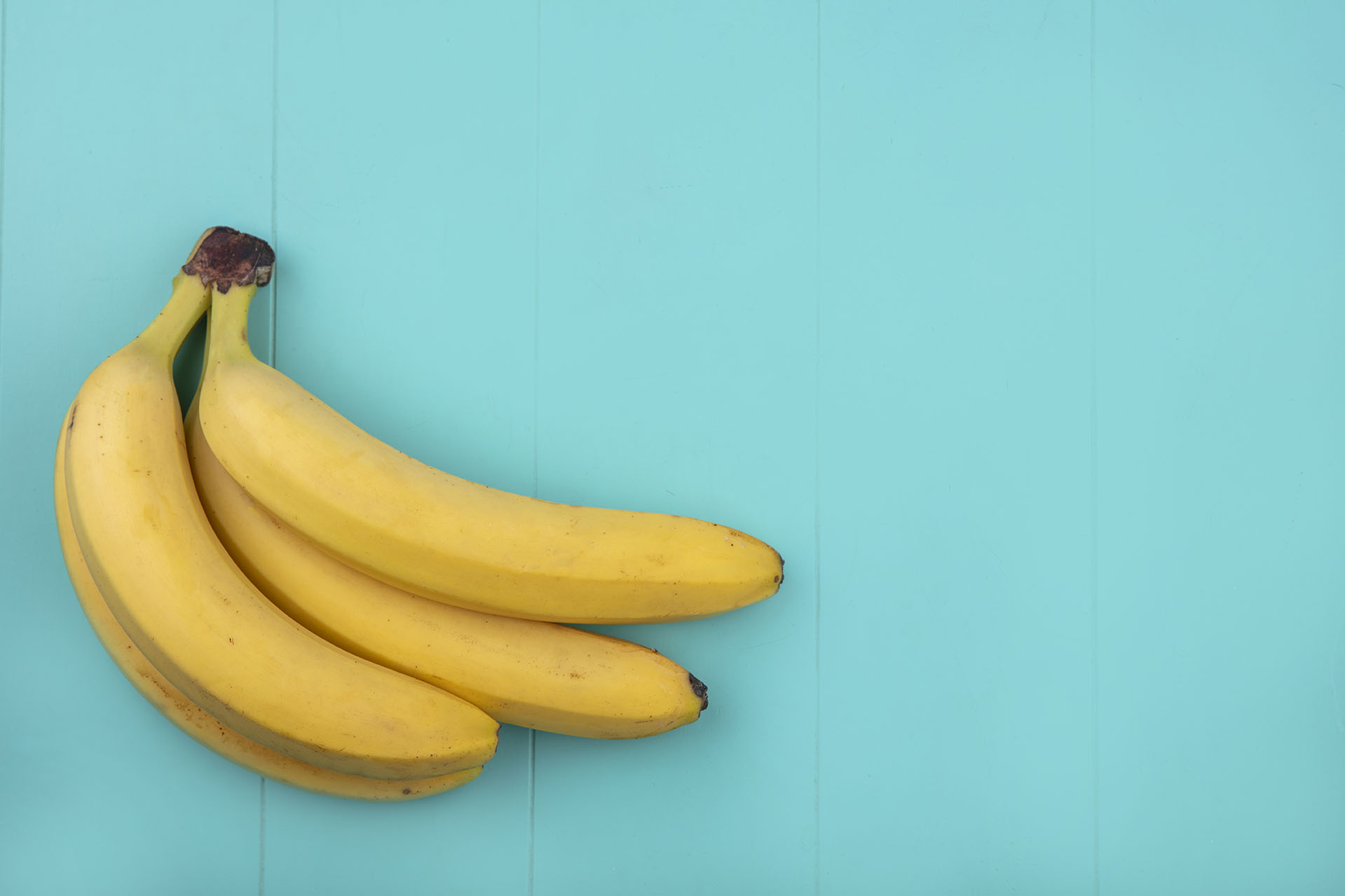 top view copy space bananas on a turquoise background